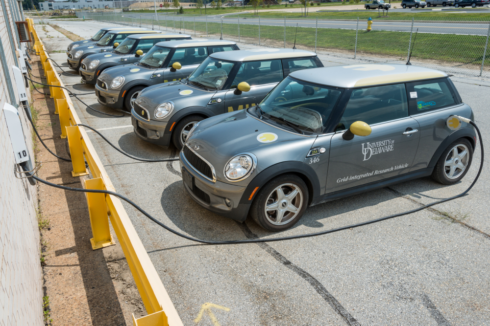 University of Delaware under Dr. Willett Kempton has demonstrated the environmental and economic benefits of vehicle to grid (V2G) through pilot programs like a fleet of 15 BMW Mini Coopers participating in PJM's ancillary service markets for frequency regulation.